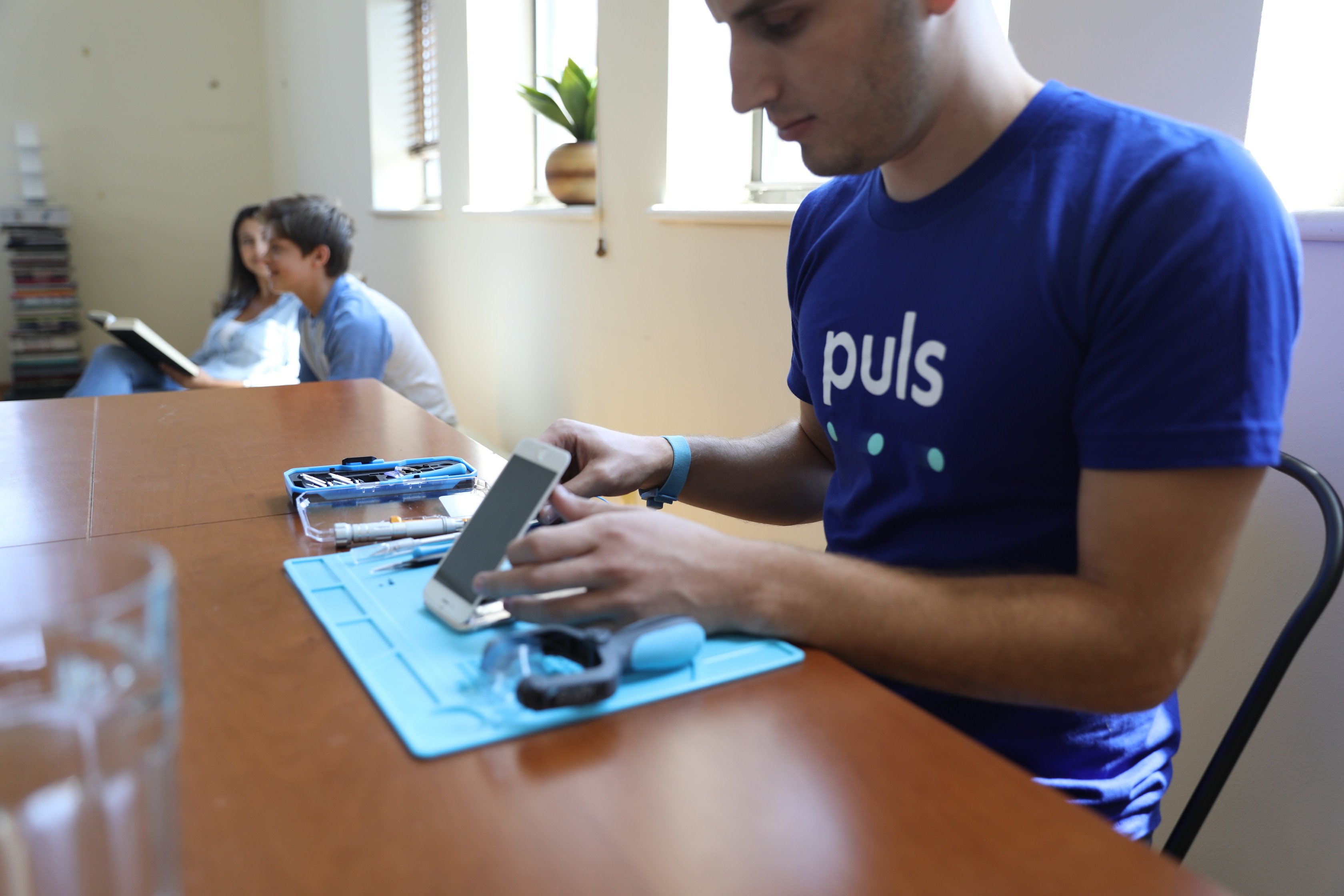 Puls technician fixing an iPhone