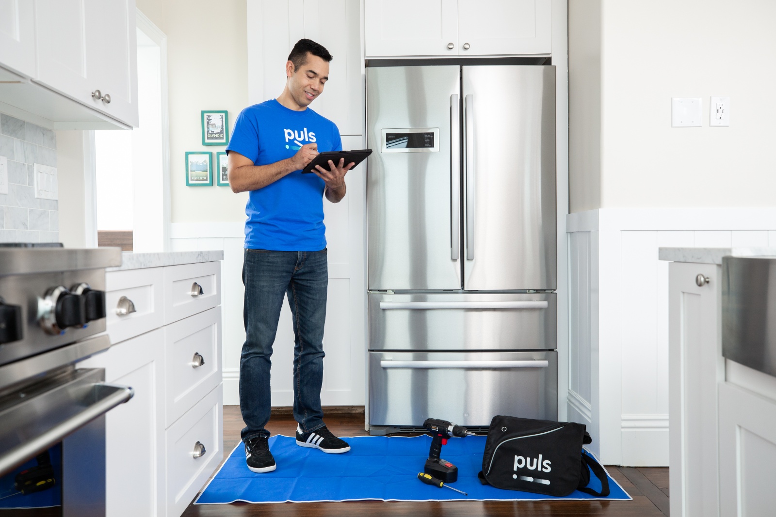 Puls technician inspecting a refrigerator