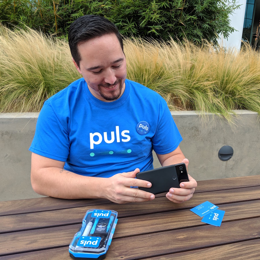 Austin iPhone repair - look to Puls puls technician looking at pixel 2 phone