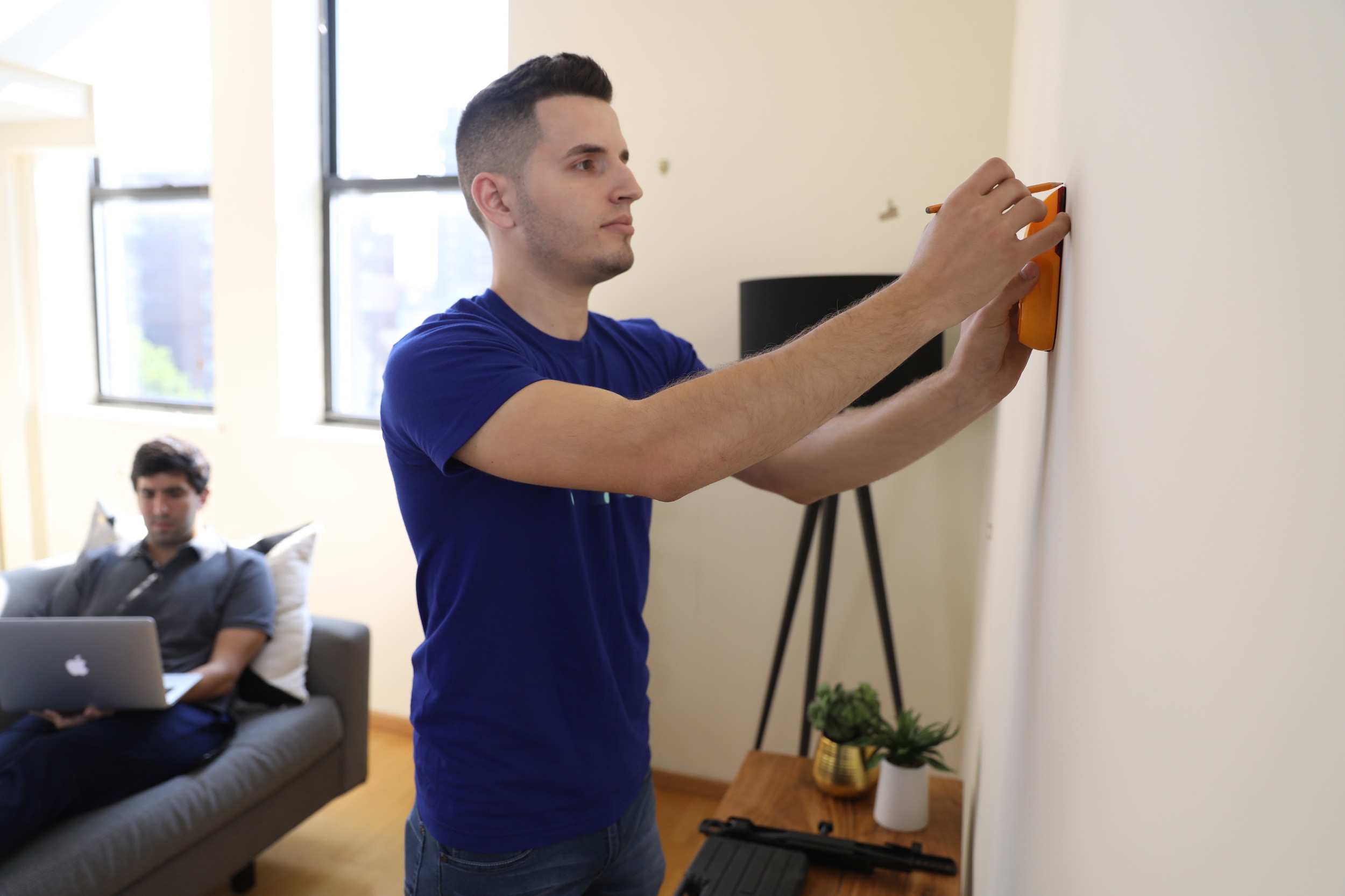 man planning where to hang tv wall mount