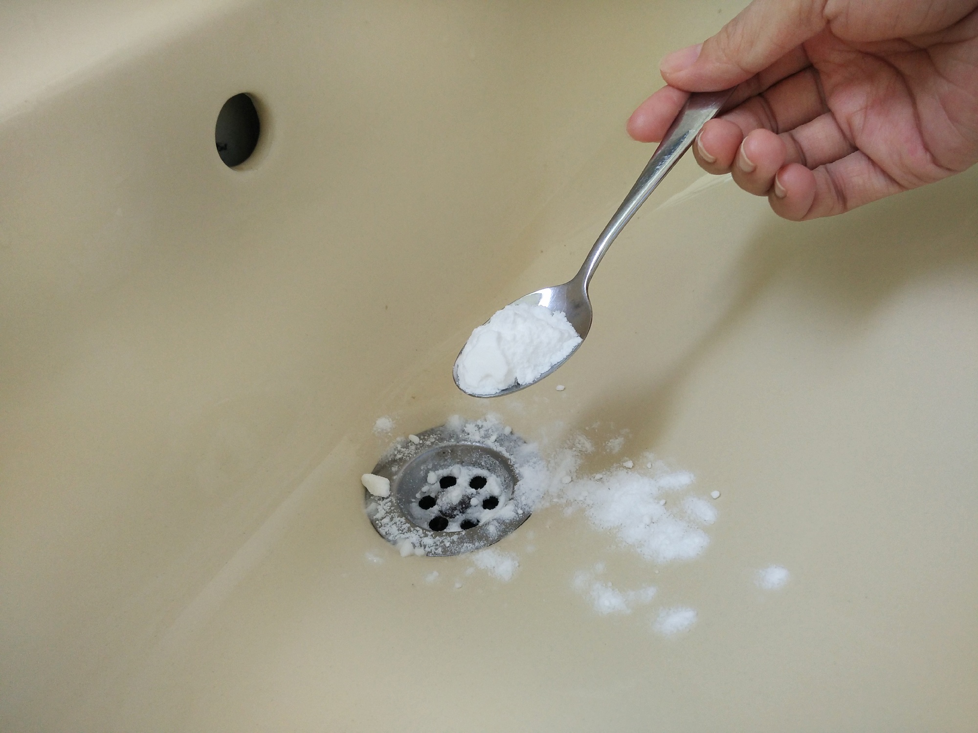 pouring baking soda down drain